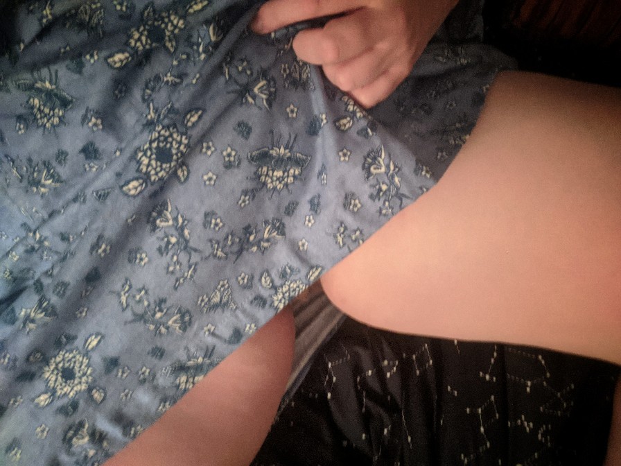 woman pulling up a blue flannel nightgown to reveal upper thighs