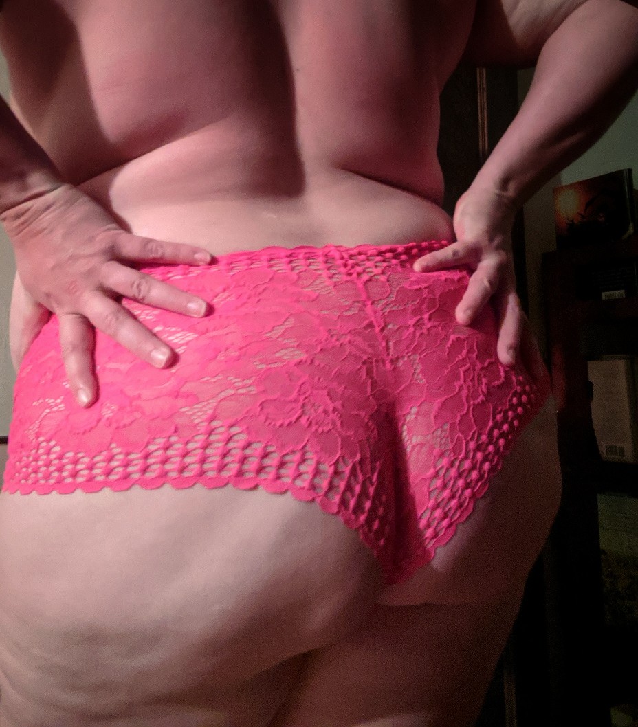 Color photo, hands, pink lace panties, behind